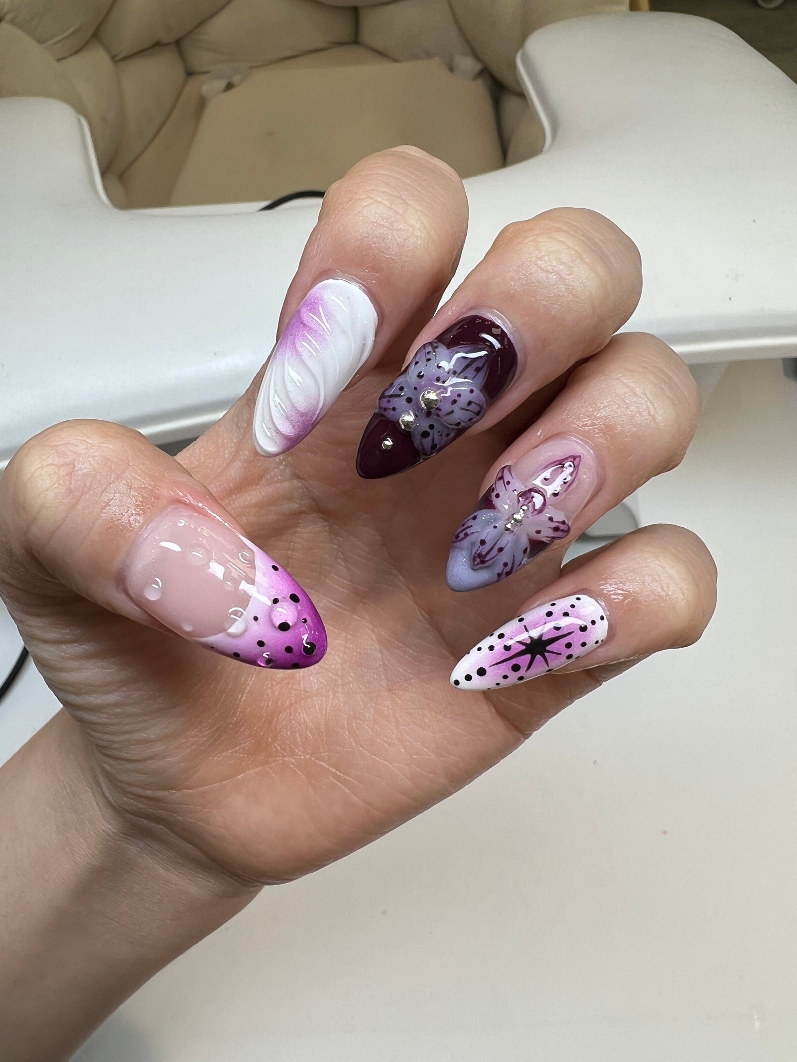 Purple and white almond nails with airbrush, marble and star art