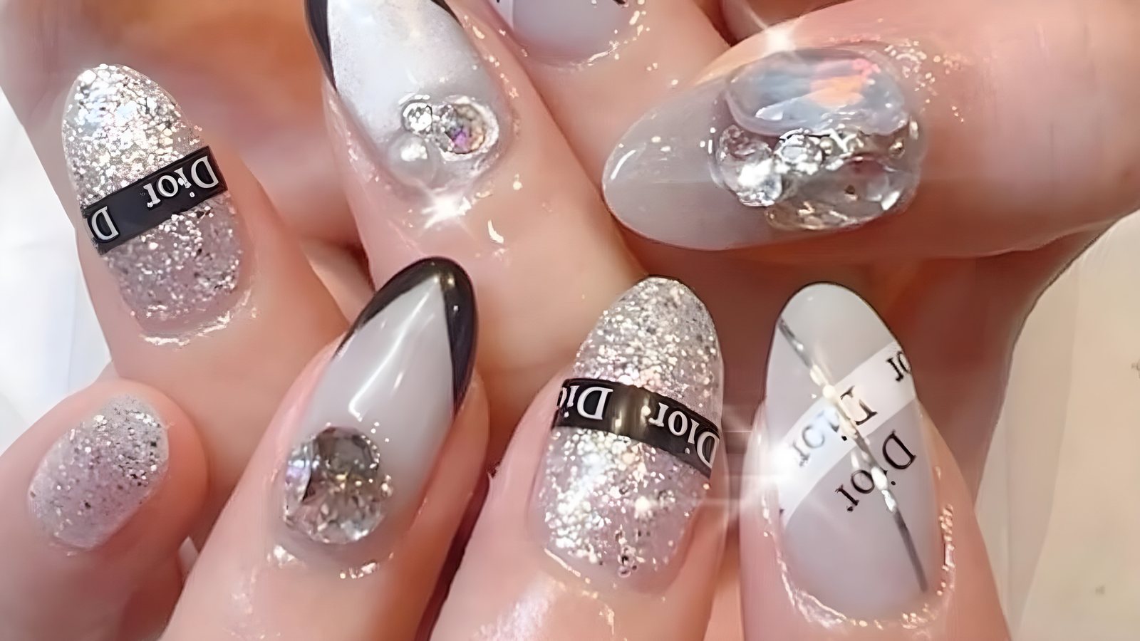 Silver glitter and grey nails with large crystal stone art