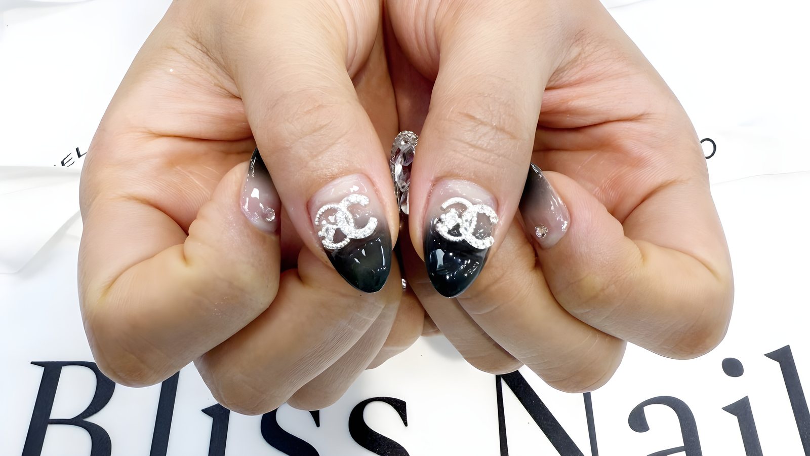 Black ombré nails with crystal charm accents